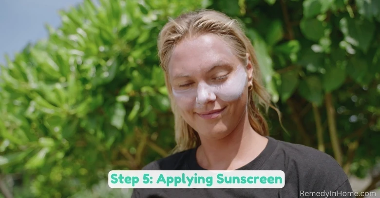 Image of a blond caucasian female surfer applying SPF sunscreen on her face, focusing on her cheeks and nose as a part of her morning skincare routine for sun protection